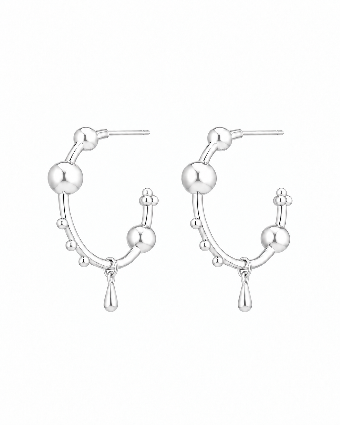 Orbit sterling silver sculptural hoop earrings on a white background
