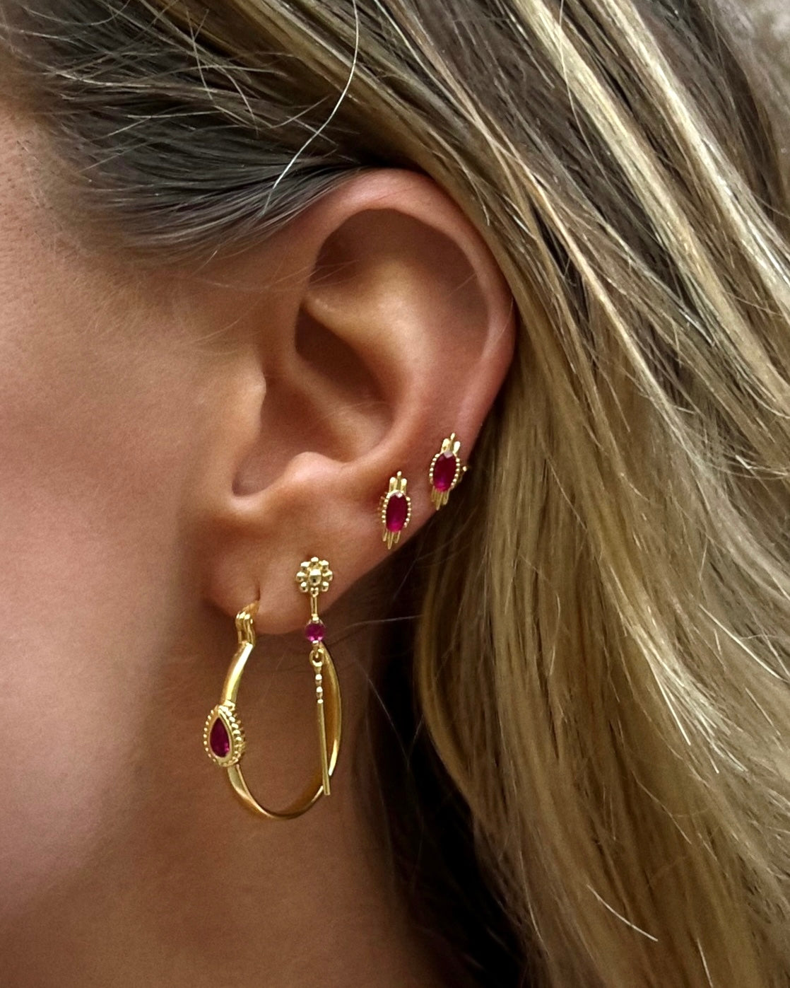 Woman wearing affordable gold-plated hoop and ruby-inspired stud earrings – Cami Citrine earring stack set