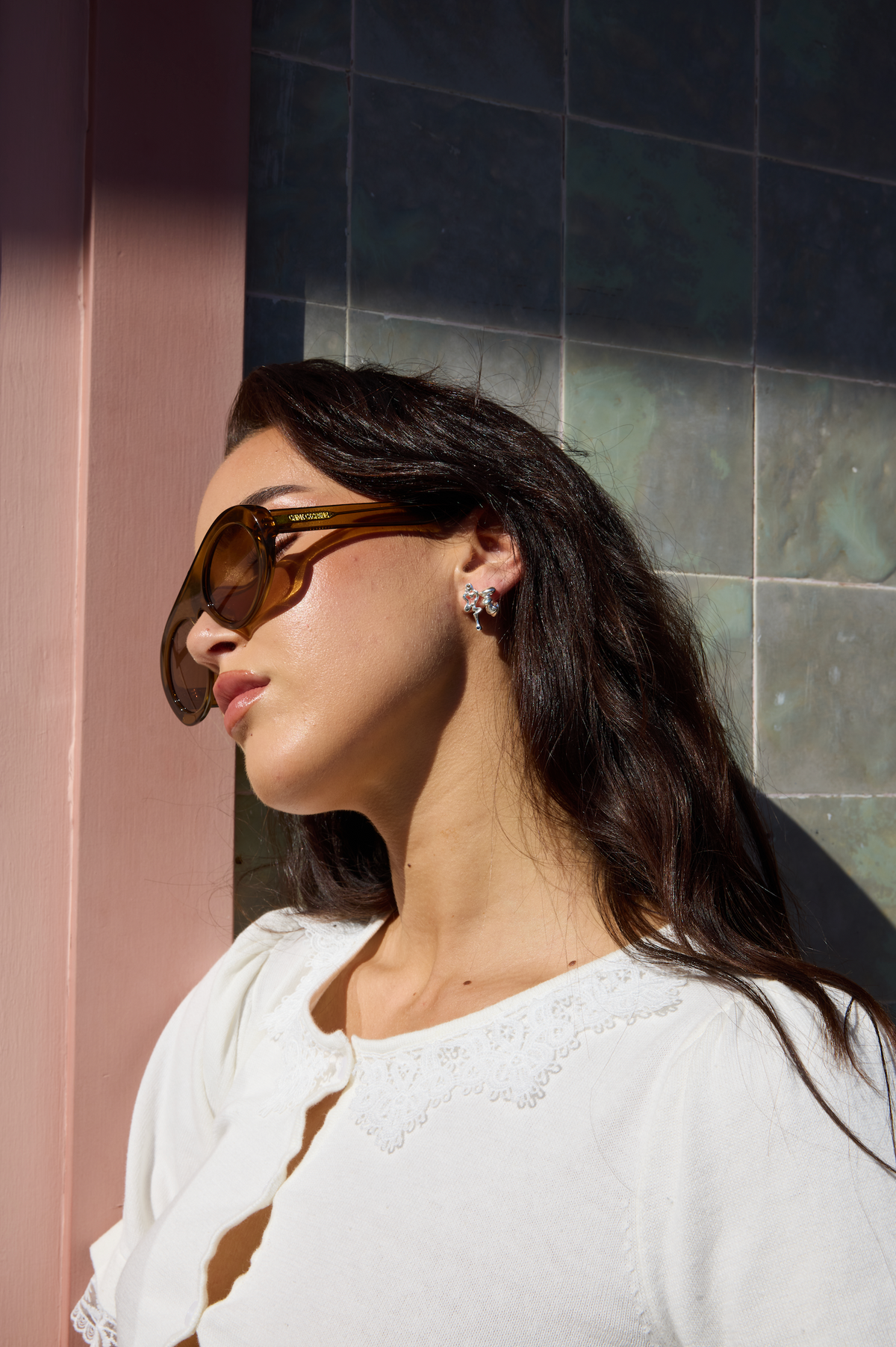 Model wearing the Lucius silver-tone earrings